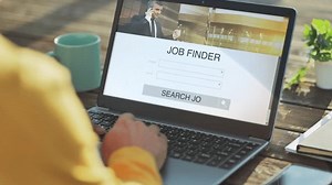 searching job at the computer using online application,back view of male at the laptop looking for occupation,vacancy on internet search engine work app