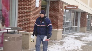 Postal worker pushes through the cold to deliver mail to the community