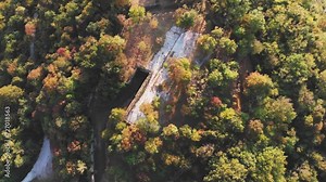 Old world war fortification building ruins in countryside with beautiful nature color landscape. Italy old building in mountains. Cinematic video over the Italian ruins of a military fort in the woods