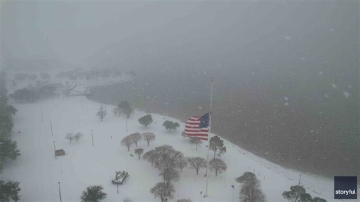 US Flag Blows in the Wind in Snowy Lake Charles