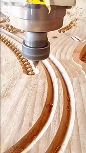 Wood carving automation, A CNC router bit cutting intricate curves into timber