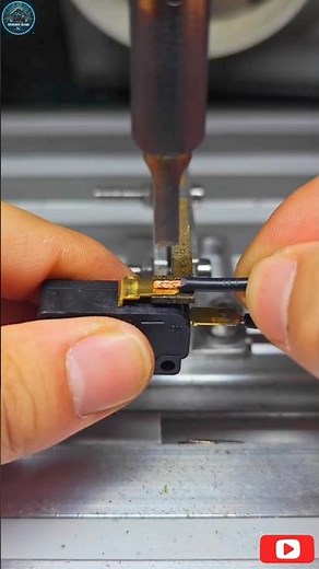The video displ soldering a wire to an audio jack connector using a semi-automatic soldering machine