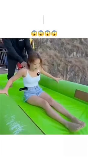 knowledge_verse.. | - The post features a 10-second video of a woman accelerating down a steep green-to-blue inflatable waterslide on a mountainside cliff,... | Instagram