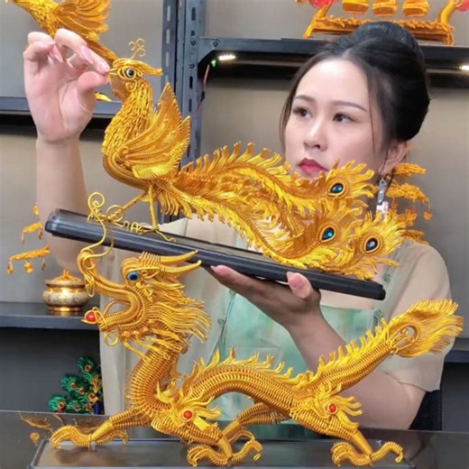 100K views · 178 reactions | Catch a glimpse of the captivating artistry of two "hardcore" pieces. Drawing inspiration from traditional Chinese weaving techniques, this Chinese artist has intricately woven golden hard metal wires to create lifelike representations of a flying dragon and a singing phoenix. This innovative approach breathes artistic temperament into the metal wires, presenting a new style of folk art. #FunChina #Heritage | China Plus America | Facebook