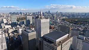 View above the endless skyline of Tokyo on a blue sky day. Panoramic from Tokyo Metropolitan Government Building in Shinjuku, Tokyo.