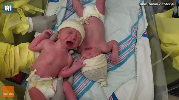 Crying newborn twins comfort each other when placed together