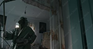 Radiation background of the settlement in the area of the Chernobyl zone. The dosimetry in the chemical protection cloak measures the radiation level in an abandoned rural home.