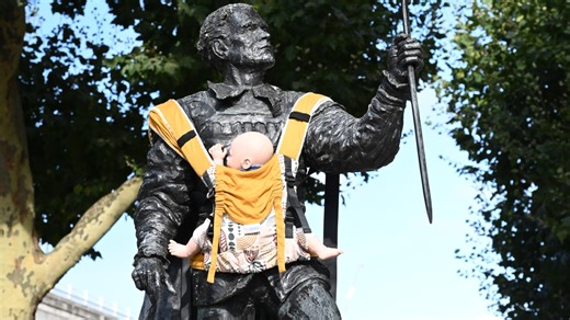 U.K. dads are wrapping baby slings on male statues to push for more paternity leave