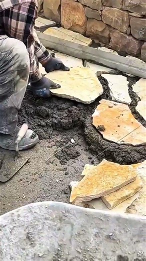 leveling stone pavers with mortar and tool to create solid and aesthetic path for outdoor landscape