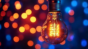 A light bulb that is lit up in front of a blurry background