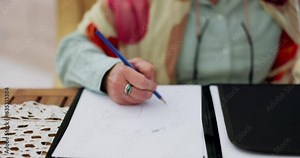 Hand holding, writing and senior woman draw clock for dementia, memory loss or self assessment in nursing home. Alzheimers, remember and old lady with mistake, fail or time sketch for cognitive exam
