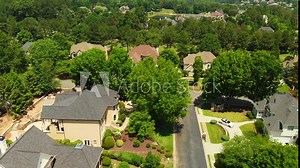 Aerial drone footage shot in 4K of an upscale suburbs with beautiful houses and manicured lawns in suburbs of Atlanta.