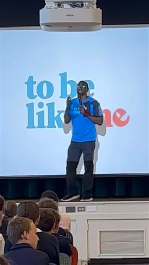 LEADer Mel shares about limb differences with the 6th graders from Shelton! Thank you for visiting us at To Be Like Me and learning about empathy and kindness from all of our LEADers! Video description: Mel, on stage in the cafeteria, stands in front of a projector screen holding a microphone. He shares about limb differences to a group of students, and runs, jumps, and dances before revealing and uncovering his right leg that has a prosthetic limb. #LimbDifferences #ToBeLikeMe #TBLM | To Be Lik