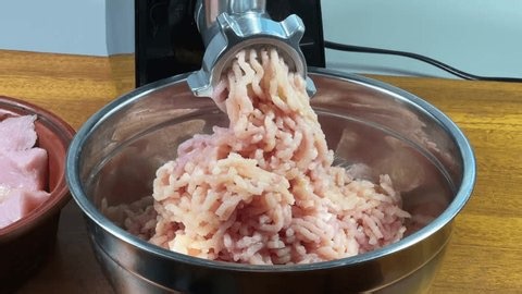 clip-4030614487-grinding-mix-turkey-chicken-meat-into-ground