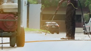 High pressure cleaning,lower body. Heavy duty gasoline high pressure cleaner operating cleaning driveway , professional cleaning services .