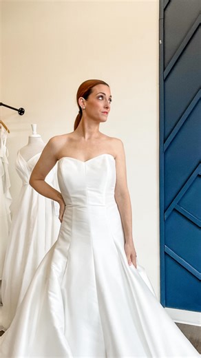 Meet Carnation! The drop waist of your dreams is here 2026 Nebraska Brides!! She is a Mikado gown with detachable off the shoulder sleeves with the coolest floral details! We have her sampled in a bridal 16 and she can be ordered 0-32W! Her back is absolutely stunning with the open corset detailing and Faux buttons over the zipper! Martin Thornburg has done it again! Nebraska bride, still searching for your perfect wedding gown for your 2026/2027 wedding?? White and Ivory in Lincoln Nebraska is 