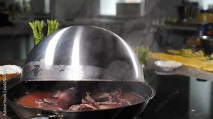 Cooking octopus by boiling it in pan with steam rising up on black background. Seafood cooking in restaurant kitchen. Delicious big octopus boiling in frying pan. water boiling. octopus getting ready