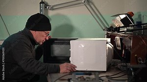 electronics repair. consumer electronics repair. microwave repair. open the microwave door. Slow motion video. High quality video in 4k