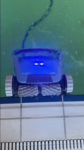 Pool cleaner robot Dolphin M600 in action! Slowly moves along the edges and removes all the dirt
