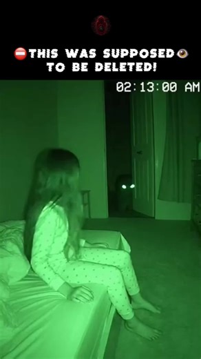 Look at the doorway👁️ Her parents installed the night vision camera because she kept waking up screaming. Night terrors, the doctor said. Normal for her age. Give it time. They watched the footage the next morning. 2:13 AM. Their daughter sitting up in bed. Awake. Calm. Staring at the doorway. Two glowing eyes in the darkness. Standing completely still. Human height. Wrong proportions. She's not scared. She's talking to it. They can't hear what she's saying - camera has no audio. But her lips a