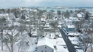 Aerial Drone footage in Hingham, MA after snowstorm, Hingham, Weymouth and Quincy bay in distance. Forward motion