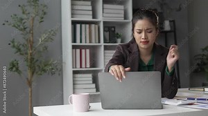 Stressed businesswoman in office dealing with computer problems, showing frustration and stress, covering face in slow motion. Perfect for work stress and technology issues concepts