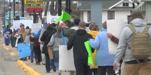 Protesters stress solidarity during march across Veterans Memorial Bridge