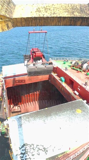 crane grab loading coal into ship hold satisfying & precise !