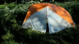 The man opens the tent, making a few photos on the phone and close...