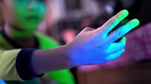 clip-1096975935-close-kid-hold-bluetooth-device-control-mobile