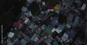 Contrast aerial flight of poor housing area, Tilt up to reveal developed business district. Urban view. Drone, 4K. Frame rate: 23.98 Video Codec: ProRes 422HQ BGC, Taguig, Manila, Philippines