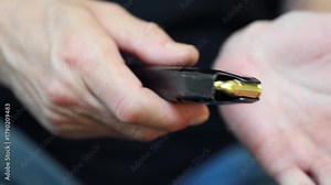 Manipulation with classic semi automatic inox compact pistol and loading magazine caliber 9x19
