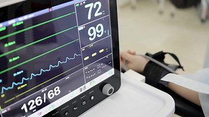 Close-up of a patient monitor displaying oxygen saturation levels, with a focus on the detailed readout. The image highlights the critical monitoring of vital signs in a clinical setting