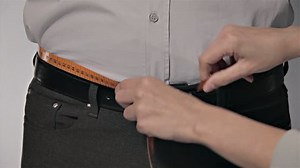 Tailor Waist Man Body Measuring. Tailor measuring different parts on a mans body for a suit production. Measures for making men's suits. Textile confection. Taking the steps to make a man's suit.