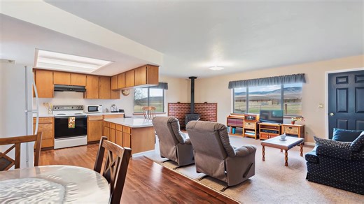 This neat and clean three-bed, one & 1/2-bath ranch home offers updated flooring and a welcoming, low-maintenance setting. The property is surrounded on three sides by BLM land, providing rare, unfettered access to wilderness, trails, and the rugged beauty of the Eagle Cap Mountains. Outbuildings are thoughtfully arranged for hobbies, work, or animals, including an oversized heated garage with power, hot water, and plumbing suited for projects or livestock, a barn designed for sheep or small ani