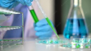 Science and medicine, scientist analyzing and dropping a sample into a glassware, experiments containing chemical liquid in laboratory on glassware, innovative and technology.