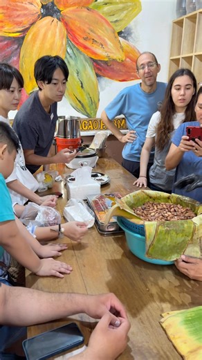 Cacao pod opening, taste testing of fresh cacao beans, fermentation process and roasting process