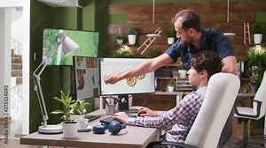 In creative agency office two designers are talking over a new gear design. They are using professional CAD or 3D software