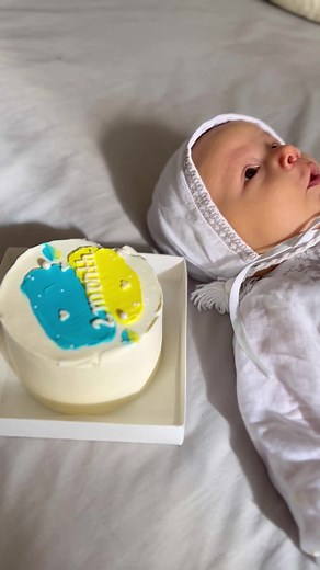 Adorable Baby in Embroidered Outfit with Colorful Cake