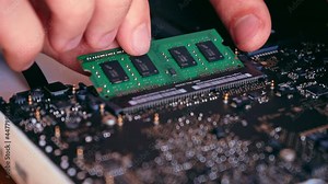 Hands holding computer RAM memory plate. Computer diagnostics concept. Laptop repair. 4K video footage.