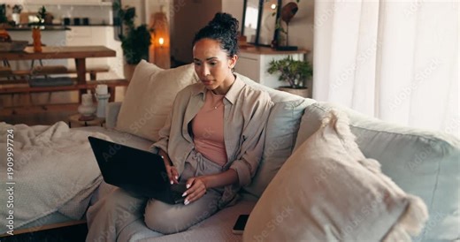 Woman, student and laptop on sofa in home for online learning, typing and university portal for assignment. Female person, education and study with elearning forum, chat or writing thesis at house