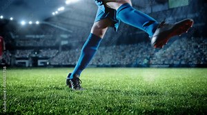 Football World Championship: Soccer Player Runs, Kicks the Ball. Ball Shoots, Grass Sprays Outwards, Full Stadium Crowd Cheers. Camera Moves in Arc Super Slow Motion. Cinematic Shot Captures Victory