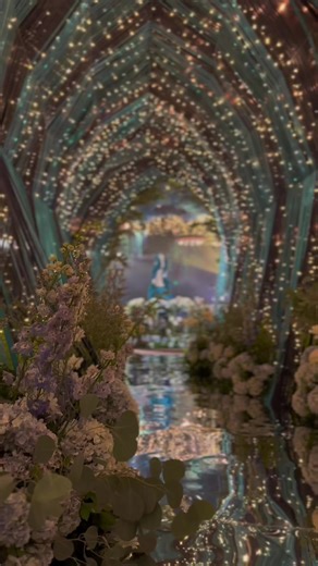 Inspired by the aurora borealis, we used different colored elements, mirror flooring and our signature sparkling lights for this #kynofied 40 feet long tunnel ✨ #starrynight #starrynightwedding #auroraborealis #wedding #weddings #weddingsph #weddingdecor #weddinginspiration #entrancetunnel