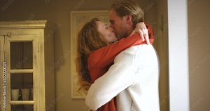 Love, home and couple kissing while hugging and spending time together inside their home. Happy, loving and carefree boyfriend and girlfriend showing affection while bonding in their cozy apartment