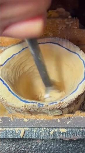 A piece of wood that is being scraped neatly using special tools by a craftsman