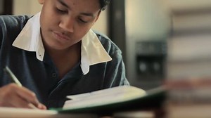 Teenage boy studying - doing his homework