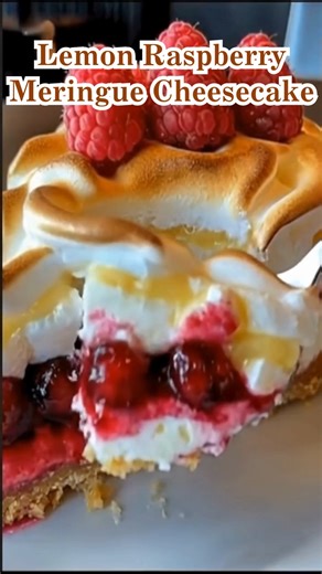Lemon Raspberry Meringue Cheesecake-Don’t Lose This Recipe Bright citrus · Juicy berries · Toasted cloud top What if a cheesecake tasted like sunshine breaking through a quiet afternoon? This lemon raspberry meringue cheesecake is all contrast and harmony — cool, creamy layers, sharp lemon curd, pockets of raspberry brightness, and a toasted meringue top that feels light as air but rich with comfort. What You’ll Need For the Crust Crushed vanilla biscuits (plain, non-branded) Melted butter For t