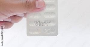 Close-up of medicine or vitamin pack with production date and expiration date. Reading the expiry date. Concept of food security, food supplement, medicine, health, food safety. 4k resolution.