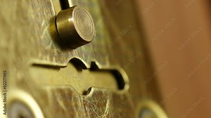 Key sliding into lock and locking\ unlocking door. 4K UHD.