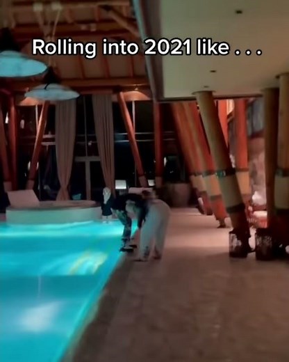 Girl tries to push other girl in the pool, and falls in herself.